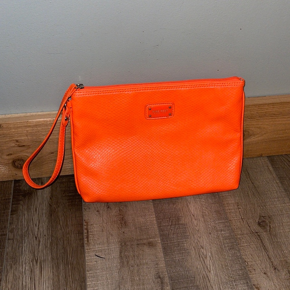 Nine West orange wristlet/clutch. 12” W x 9”H x 7” D opening.